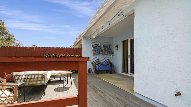 wooden terrace featuring fence