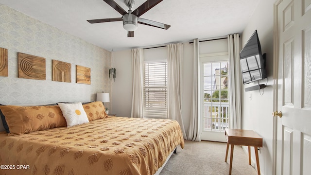 bedroom featuring ceiling fan, carpet floors, access to exterior, and wallpapered walls