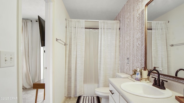 bathroom featuring toilet and vanity