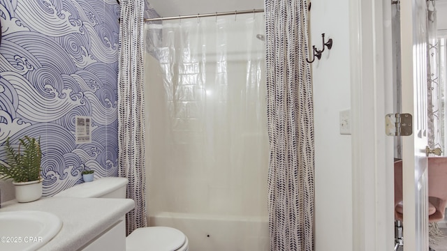 full bathroom featuring vanity, shower / tub combo, and toilet