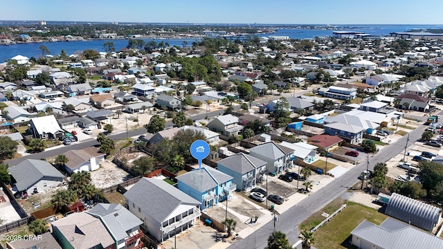 drone / aerial view featuring a residential view and a water view