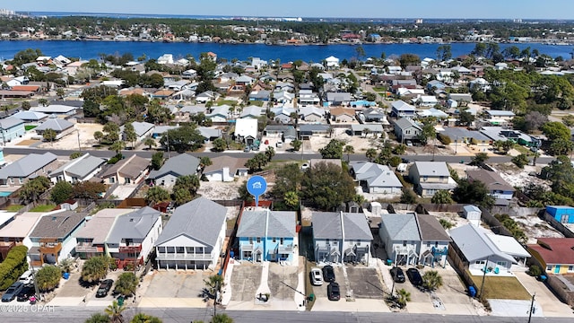 drone / aerial view featuring a residential view and a water view