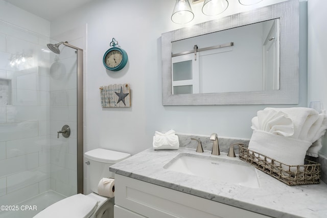 full bath featuring toilet, tiled shower, and vanity