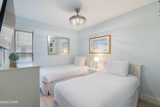 bedroom with wood finished floors and baseboards