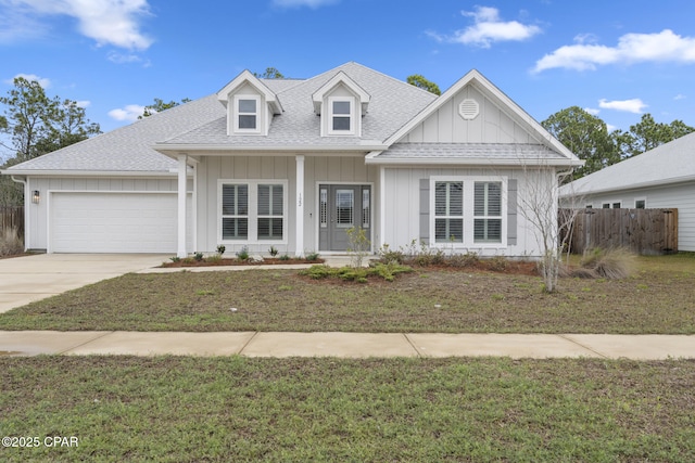 view of front of property with fence, roof with shingles, an attached garage, concrete driveway, and board and batten siding