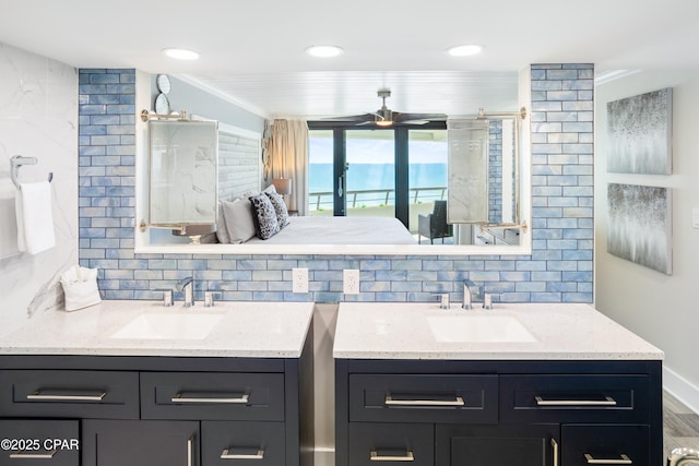 bathroom with a sink, decorative backsplash, and two vanities