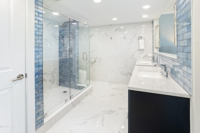 full bath featuring a sink, recessed lighting, a marble finish shower, tile walls, and double vanity