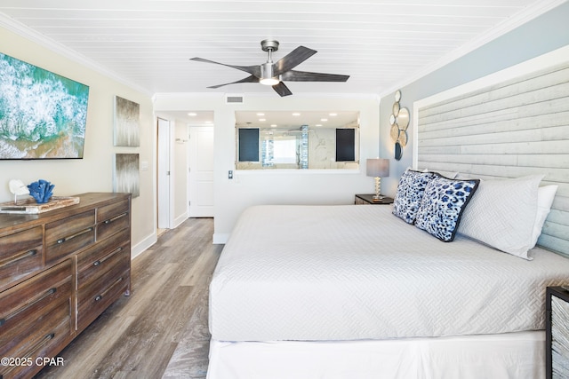 bedroom with visible vents, ceiling fan, baseboards, ornamental molding, and wood finished floors