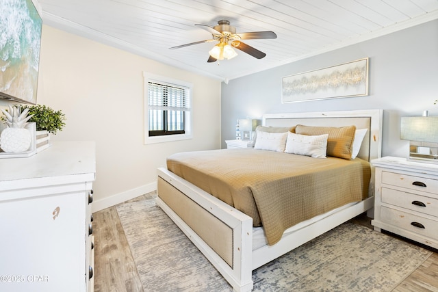 bedroom with light wood-type flooring, a ceiling fan, crown molding, baseboards, and wood ceiling