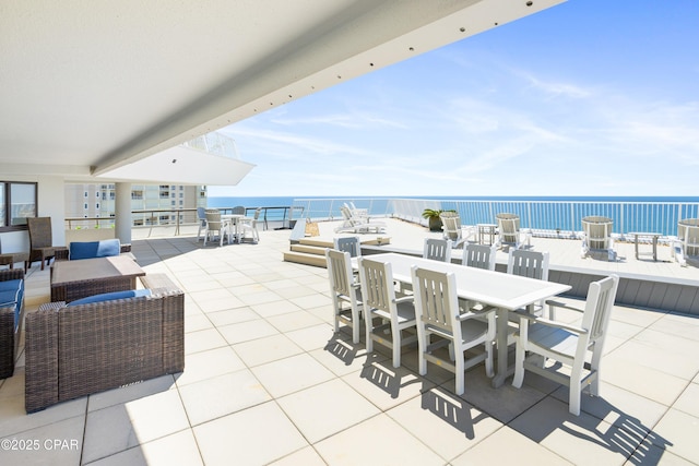 view of patio with outdoor dining area and a water view