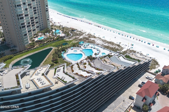 birds eye view of property with a view of the beach and a water view