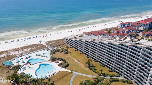 drone / aerial view with a beach view and a water view