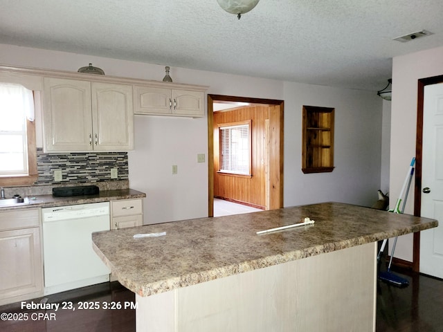 kitchen with dishwasher, a healthy amount of sunlight, visible vents, and backsplash