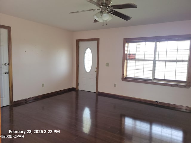 foyer with baseboards, wood finished floors, and a ceiling fan