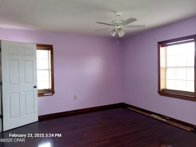 spare room with a ceiling fan, baseboards, and wood finished floors