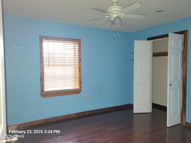 unfurnished bedroom with wood finished floors, baseboards, and ceiling fan