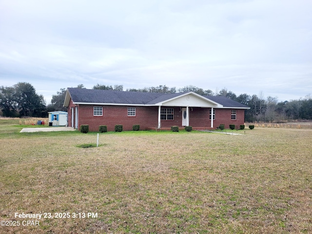 view of front of property with brick siding and a front lawn