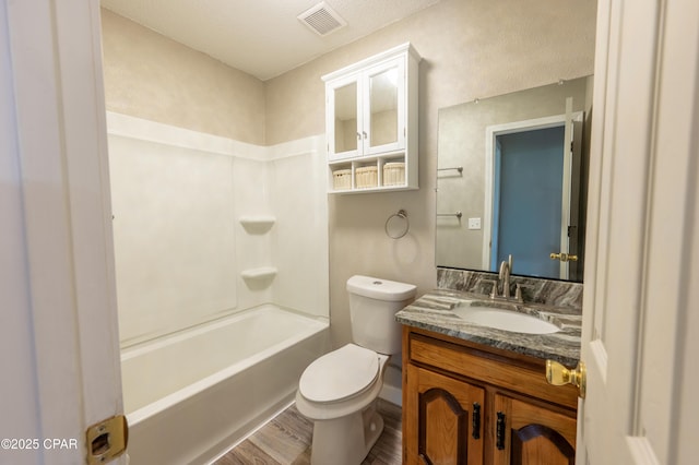 full bath featuring visible vents, toilet, wood finished floors, tub / shower combination, and vanity