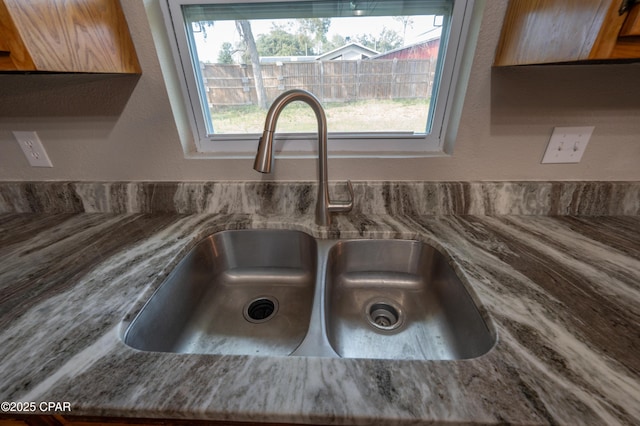 room details featuring a sink and stone countertops