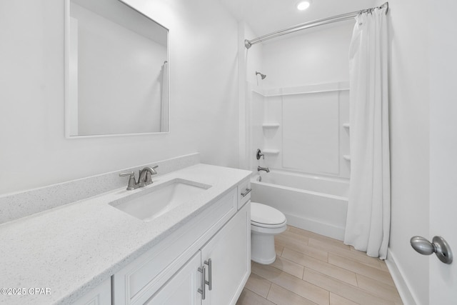 bathroom featuring vanity, toilet, shower / bath combo with shower curtain, and wood finish floors