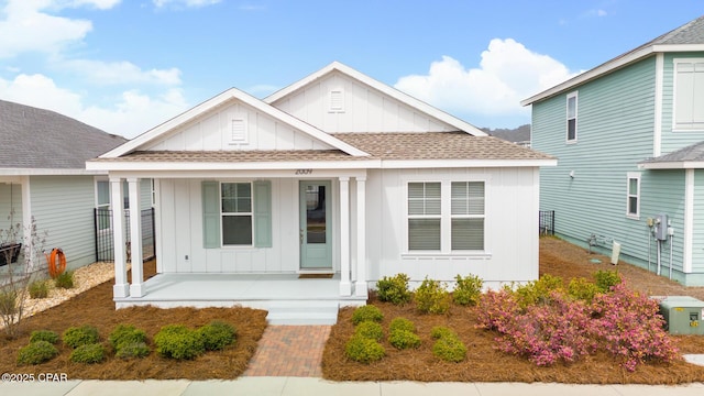 view of front of house with a porch, board and batten siding, and a shingled roof