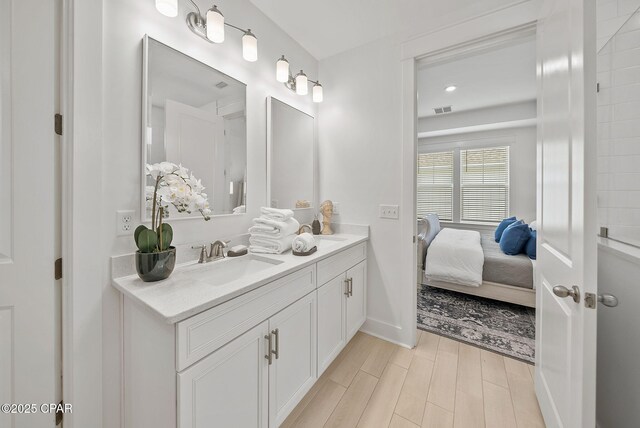 2009 Calamint St, Panama City, FL 32405 - ensuite bathroom featuring double vanity, wood finished floors, and baseboards