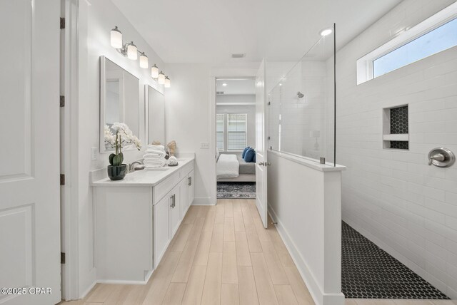 2009 Calamint St, Panama City, FL 32405 - bathroom featuring vanity, a walk in shower, ensuite bathroom, wood finished floors, and recessed lighting