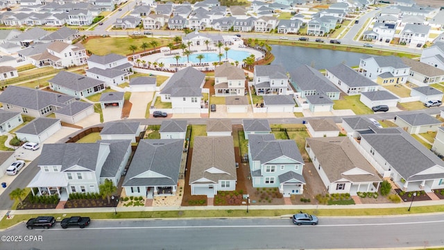 drone / aerial view featuring a residential view and a water view