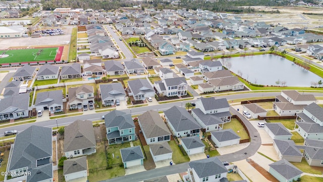 drone / aerial view featuring a residential view and a water view