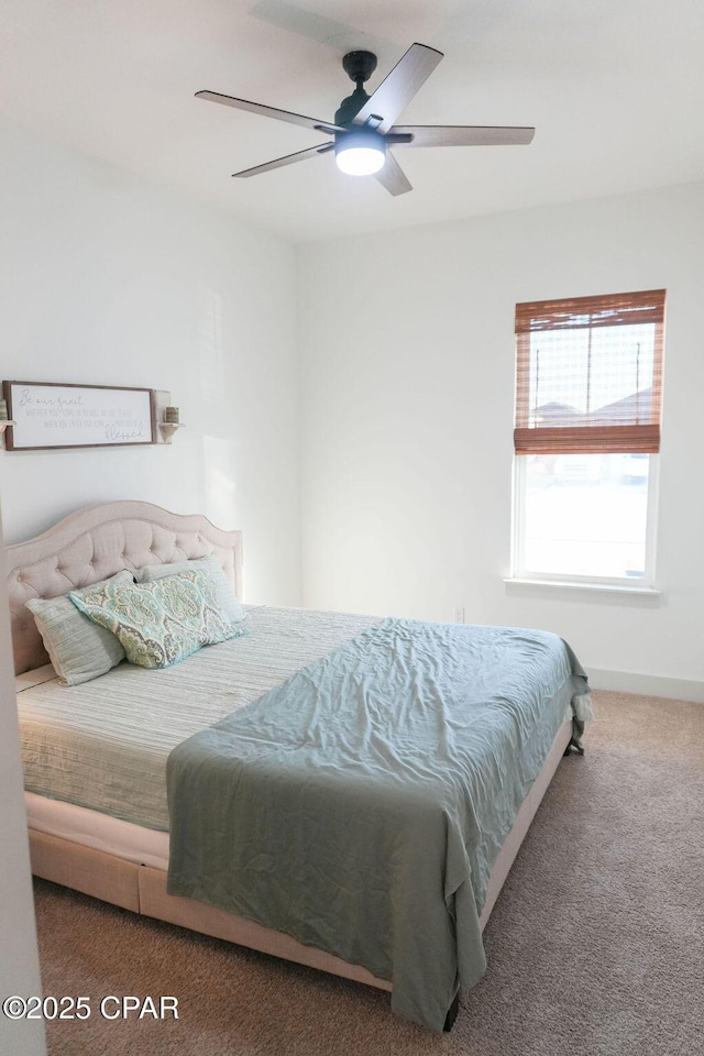 bedroom with a ceiling fan and carpet