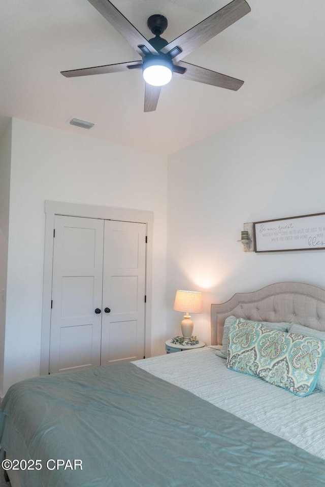 bedroom with a closet, visible vents, and a ceiling fan