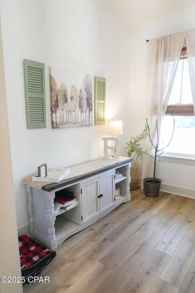 office area with light wood finished floors and baseboards