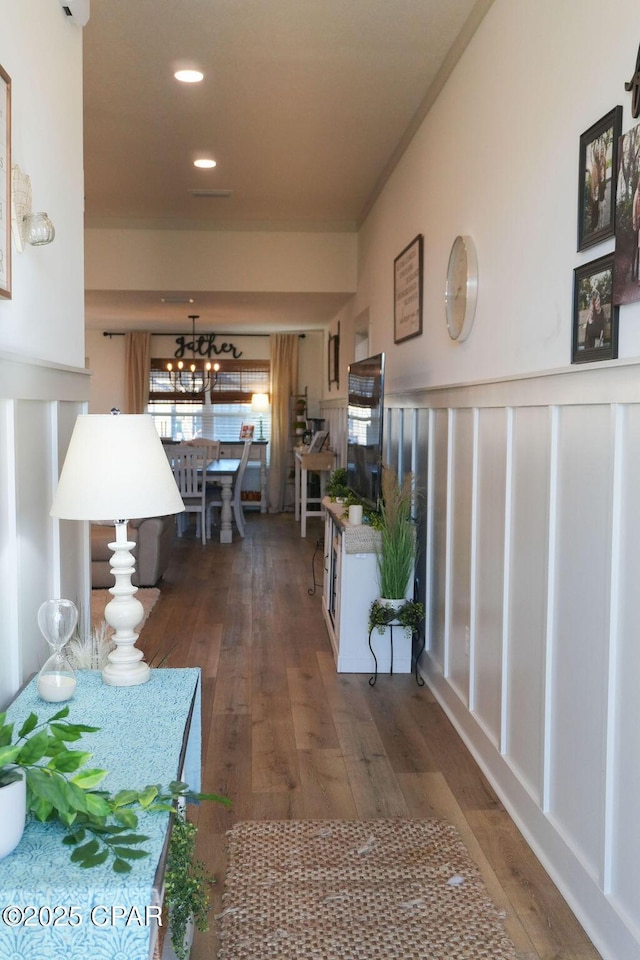 hallway with recessed lighting and hardwood / wood-style flooring