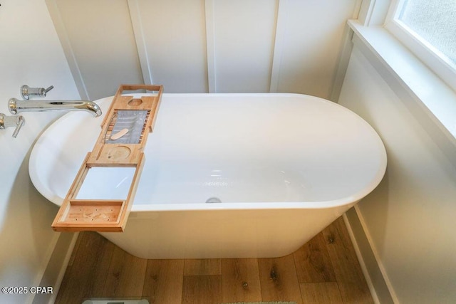 bathroom featuring a bathing tub and wood finished floors