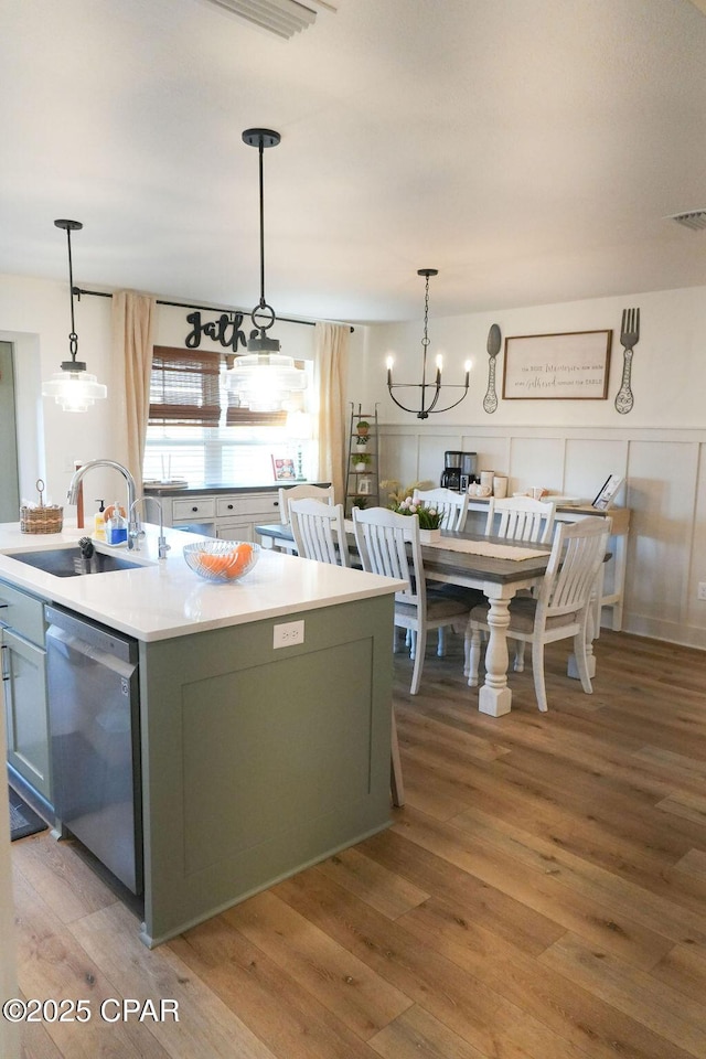 kitchen with visible vents, a sink, light wood-style floors, light countertops, and dishwasher