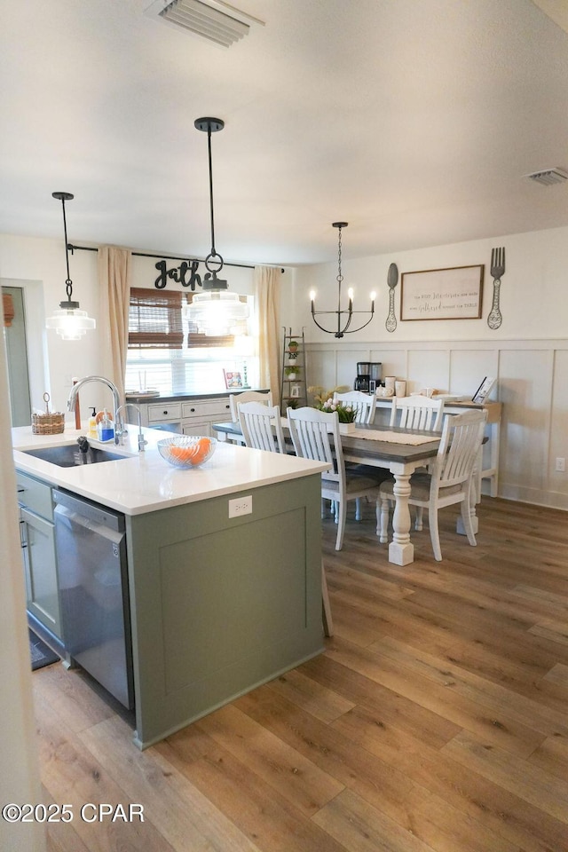 kitchen featuring a sink, light wood-style floors, visible vents, and stainless steel dishwasher