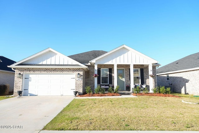 view of front facade with a front yard, an attached garage, concrete driveway, board and batten siding, and brick siding