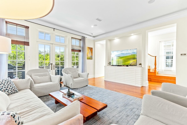239 Sand Oaks Cir, Santa Rosa Beach, FL 32459 - living area featuring visible vents, french doors, wood finished floors, and ornamental molding