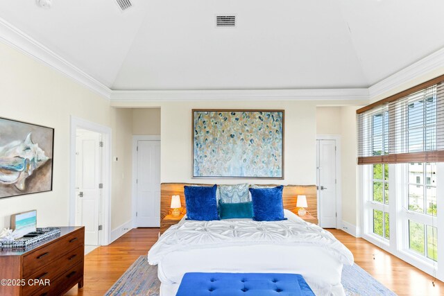 239 Sand Oaks Cir, Santa Rosa Beach, FL 32459 - bedroom with light wood finished floors, visible vents, crown molding, and lofted ceiling