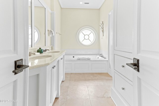 239 Sand Oaks Cir, Santa Rosa Beach, FL 32459 - bathroom with visible vents, double vanity, a sink, tile patterned floors, and a bath