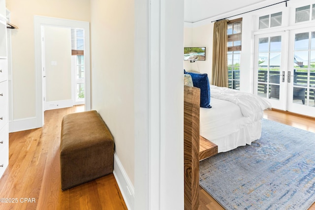 239 Sand Oaks Cir, Santa Rosa Beach, FL 32459 - bedroom with french doors, wood finished floors, baseboards, and access to exterior