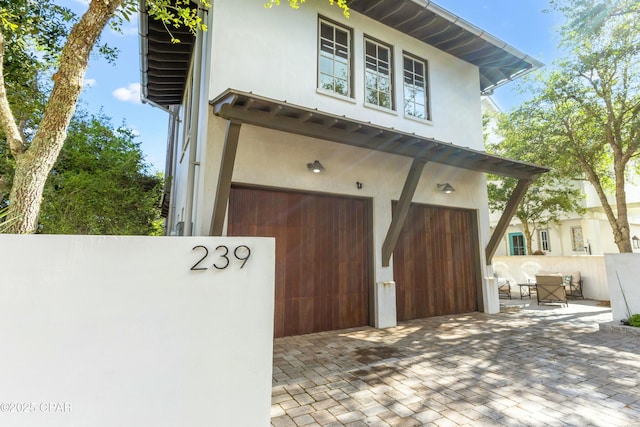 239 Sand Oaks Cir, Santa Rosa Beach, FL 32459 - exterior space featuring stucco siding and a garage
