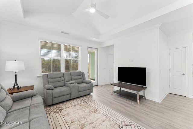 living area featuring visible vents, crown molding, ceiling fan, a tray ceiling, and light wood-style floors