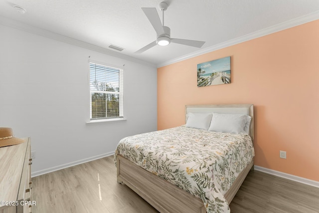 bedroom featuring visible vents, crown molding, and baseboards