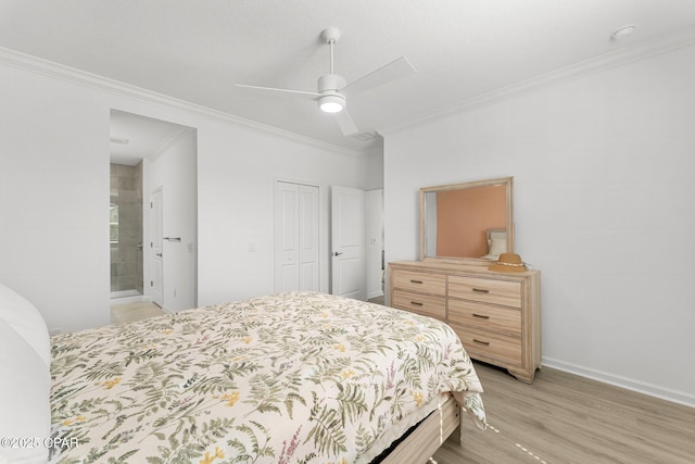 bedroom featuring crown molding, baseboards, light wood-type flooring, ensuite bathroom, and a closet