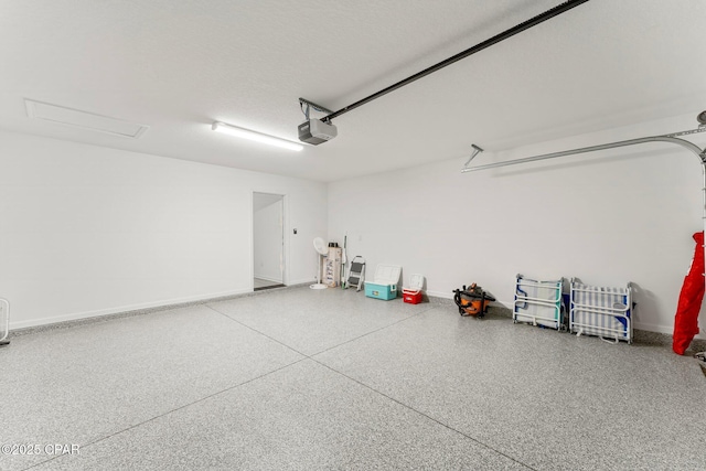 garage with a garage door opener and baseboards