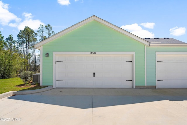 garage with central AC and driveway