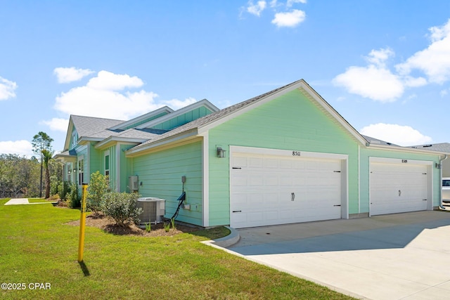 view of property exterior featuring driveway, a lawn, a garage, and central AC