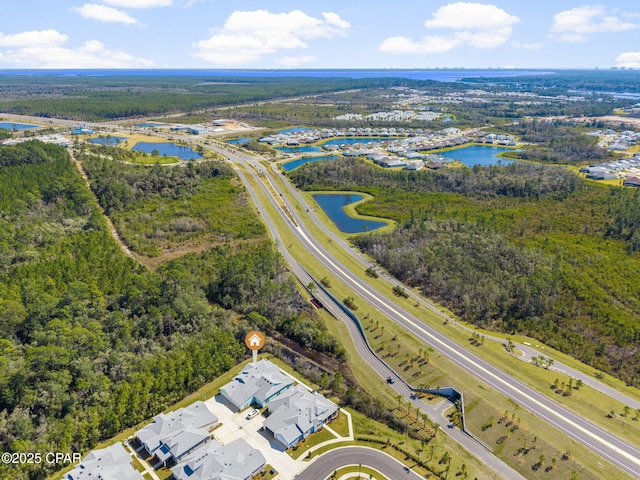 aerial view featuring a view of trees and a water view