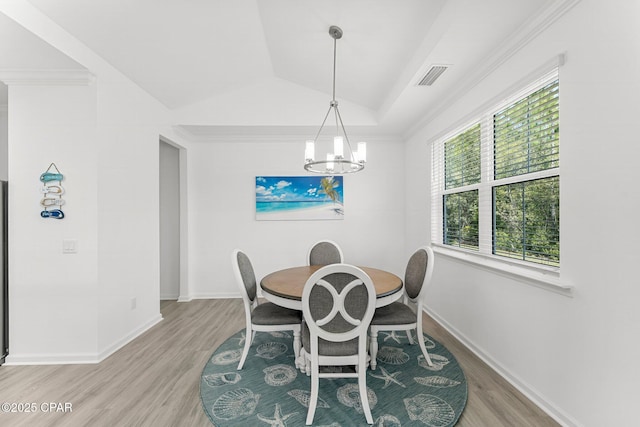 dining space with light wood-type flooring, visible vents, baseboards, and an inviting chandelier